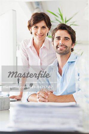 Business people smiling at desk