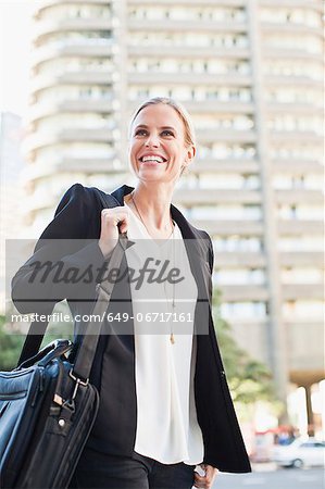 Businesswoman carrying briefcase outdoors