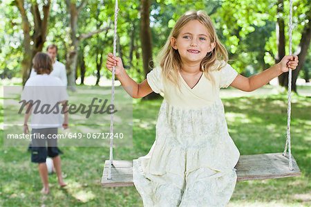Girl playing on swing in park