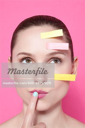 Woman with sticky notes on face