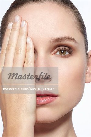 Woman with her hands over her face - a Royalty Free Stock Photo