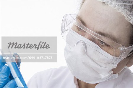 Doctor in face mask using tablet computer Doctor in face mask using tablet computer
