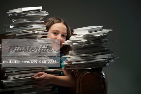 Girl holding pile of books