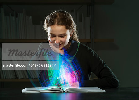 Girl reading book with multicoloured lights