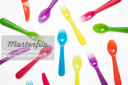 Colourful plastic knives, forks, spoons