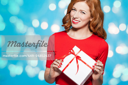 Woman holding white gift box with red bow