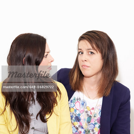 Young women arguing against white background