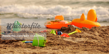 Bucket and spades on sandy beach