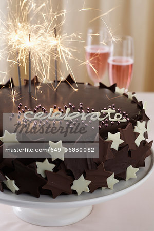 Chocolate cake with word 'celebrate' and sparklers