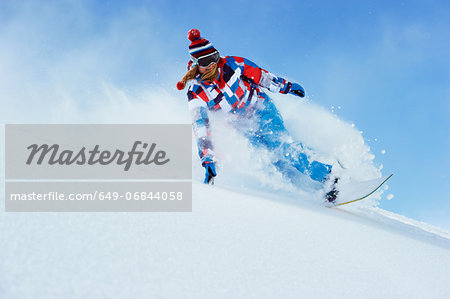 Young woman snowboarding