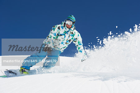 Male snowboarder in action