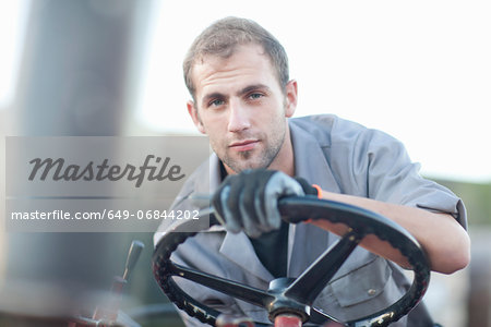 Young man at wheel of vehicle