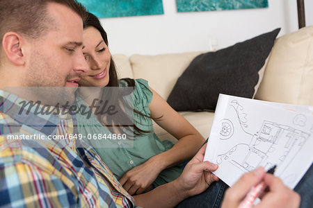 Mid adult couple sketching house plans