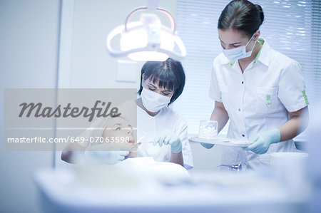 Dentist and nurse treating patient