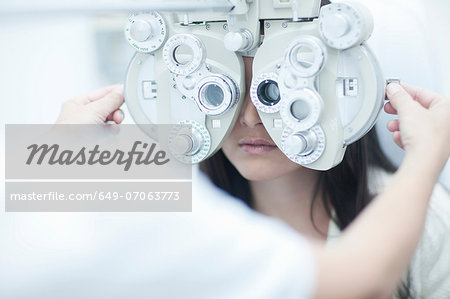 Optician testing patients sight Optician testing patients sight