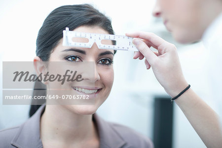 Close up of optician testing patient in eye clinic