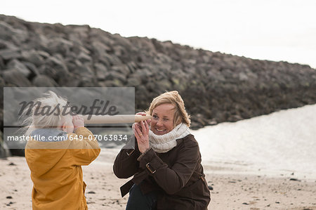 Grandmother and toddler having fun at coast