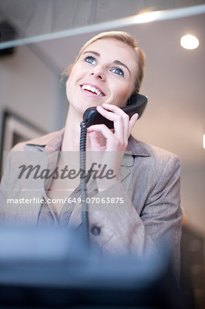 Receptionist talking on telephone