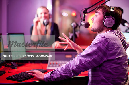 Young man and woman broadcasting in recording studio Young man and woman broadcasting in recording studio