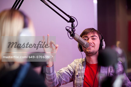 Young man and woman broadcasting in recording studio Young man and woman broadcasting in recording studio
