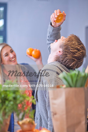 Young couple messing around in kitchen