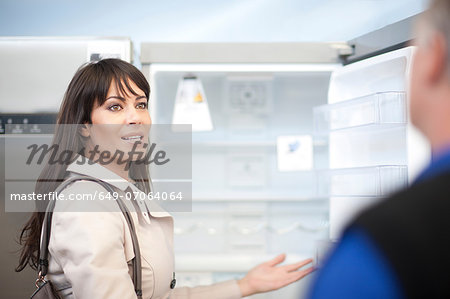 Woman looking at fridge in showroom