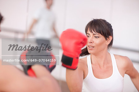 Mid adult woman with personal trainer