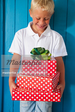 Boy looking down at gifts