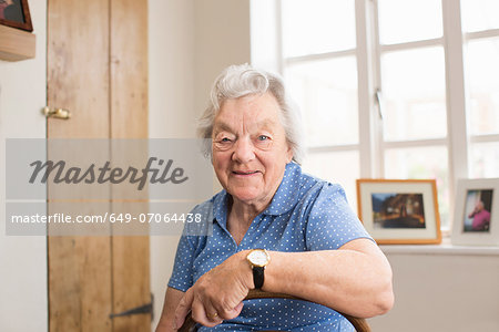 Senior adult woman sitting in room