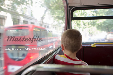 Young boy on double decker bus in London