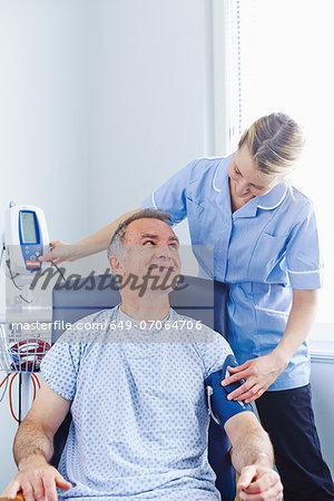 Nurse taking patient's blood pressure