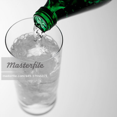 Pouring sparkling water into glass