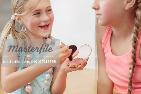 Sisters playing with make up