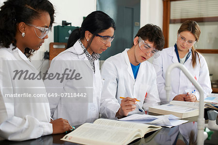 Chemistry teacher and students with text books