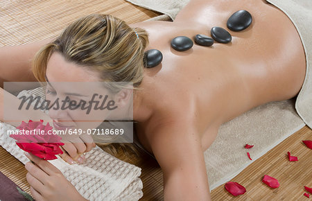 Woman enjoying a hot stone treatment