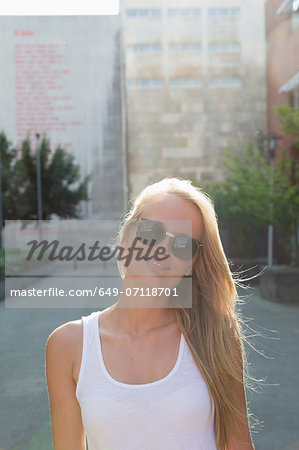 Young woman walking carefree in street