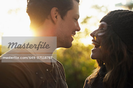Portrait of couple in autumn sunlight laughing