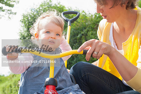 Mother with daughter on tricycle