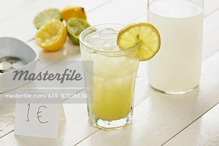 Glass of homemade lemonade with slice of lemon with 1 Euro sign