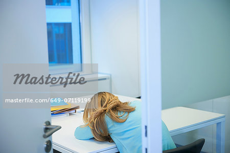 Female office worker asleep at desk