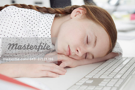 Girl asleep on computer keyboard