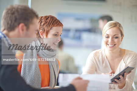 Businesspeople looking at digital tablet Businesspeople looking at digital tablet