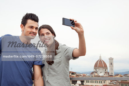 Couple photographing themselves with Florence Cathedral, Florence, Tuscany, Italy