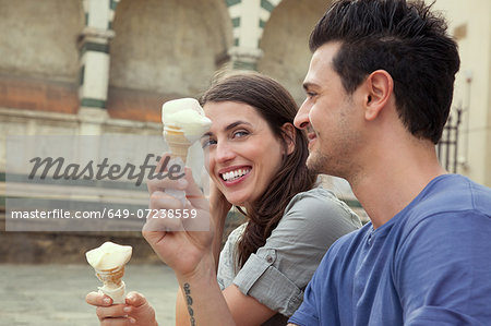 Couple eating ice creams, Santa Maria Novella square, Florence, Tuscany, Italy