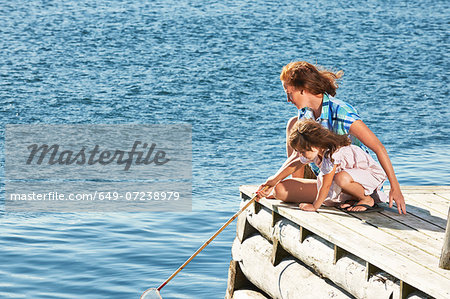 Mother and daughter with fishing net, Utvalnas, Gavle, Sweden