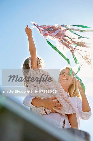 Mother and daughter playing with kite, Utvalnas, Gavle, Sweden