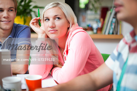 Flatmates sharing ideas around kitchen table