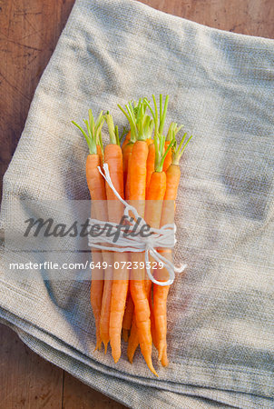 Bunch of carrots tied with string, still life