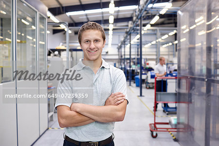 Portrait of worker with arms folded in engineering factory