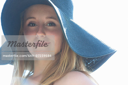 Portrait of teenage girl wearing blue sunhat